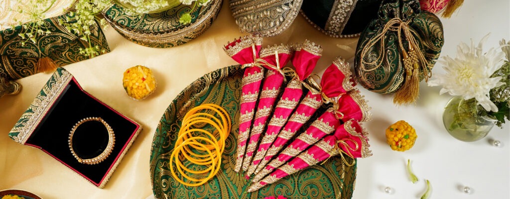 Punjabi wedding in 2025 by Navka Studio showing green shagun thaal chura and green kada box pink mehndi inside the thaal .