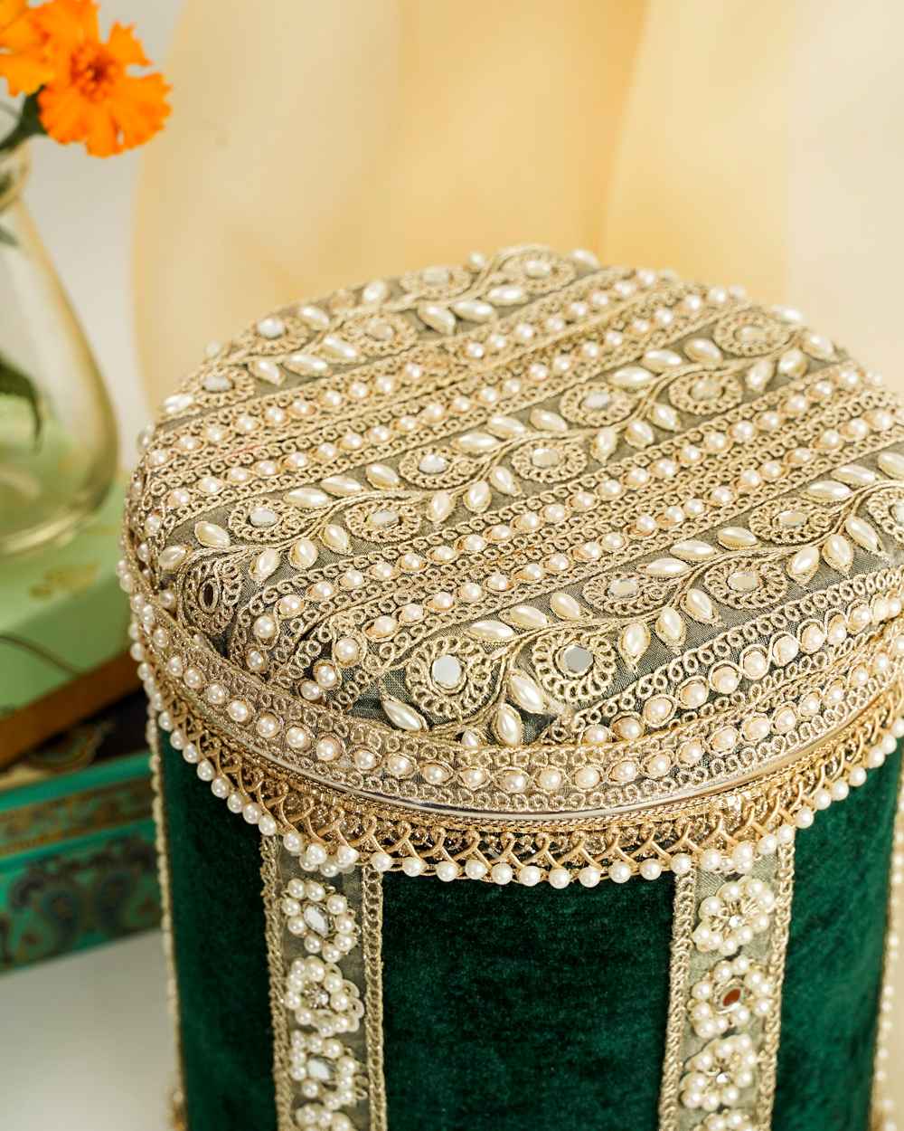 Baagh Velvet Ladoo/Bhaji Box A Baagh Velvet Ladoo/Bhaji Box by Navka Studio in green velvet, with an ornate lid of pearls, mirrors, and gold embroidery.