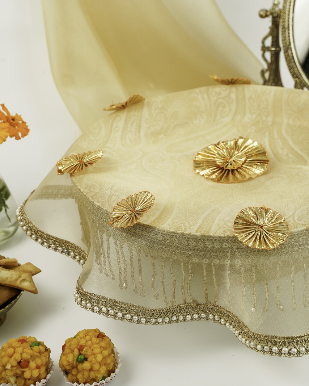 An elegant Noori Shagun Thaal with Cover by Navka Studio in sheer cream, adorned with gold gota flowers, sequins, and pearl trim.