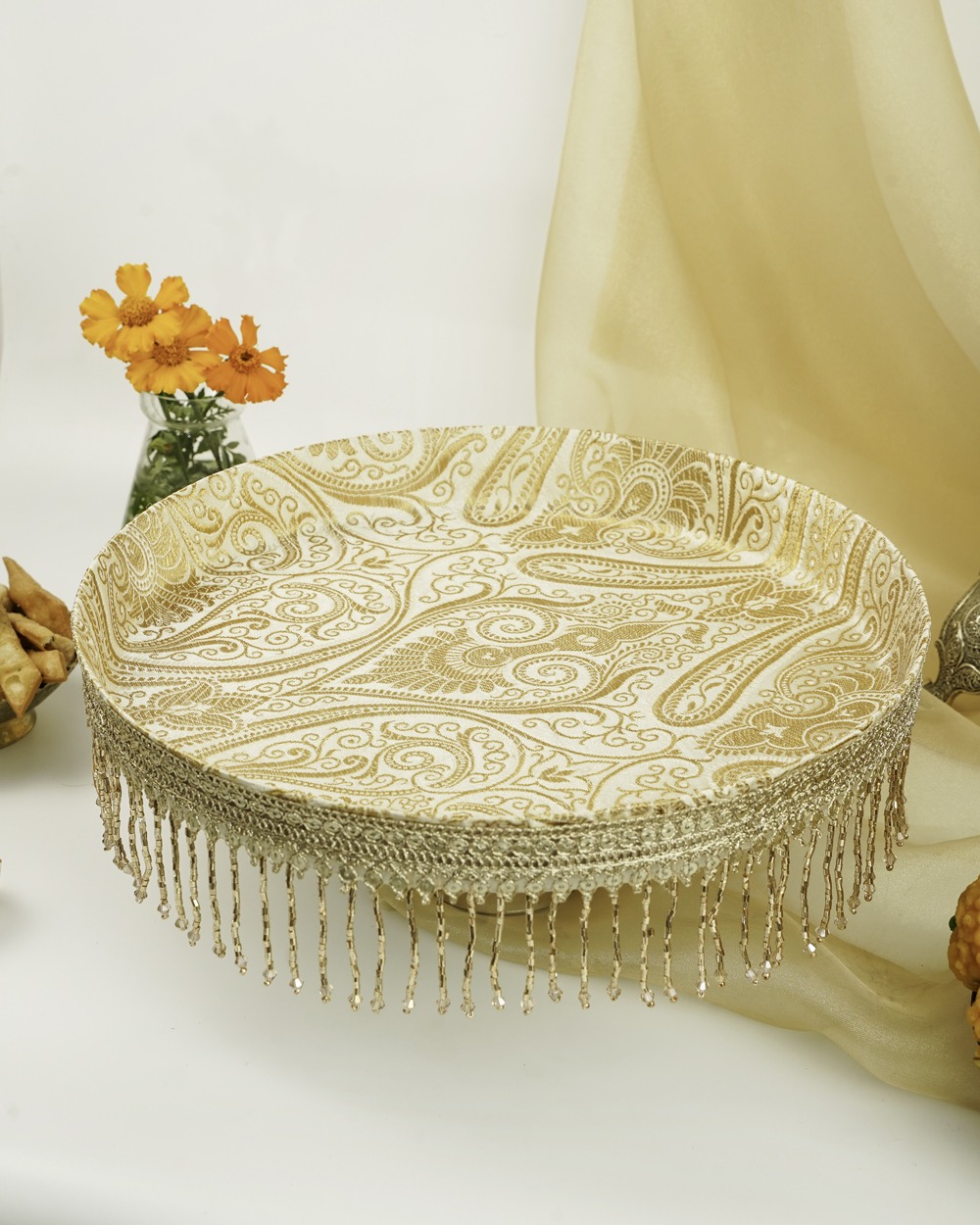 The Noori Shagun Thaal with Cover by Navka Studio, a cream and gold paisley brocade tray with an elegant beaded gold fringe.