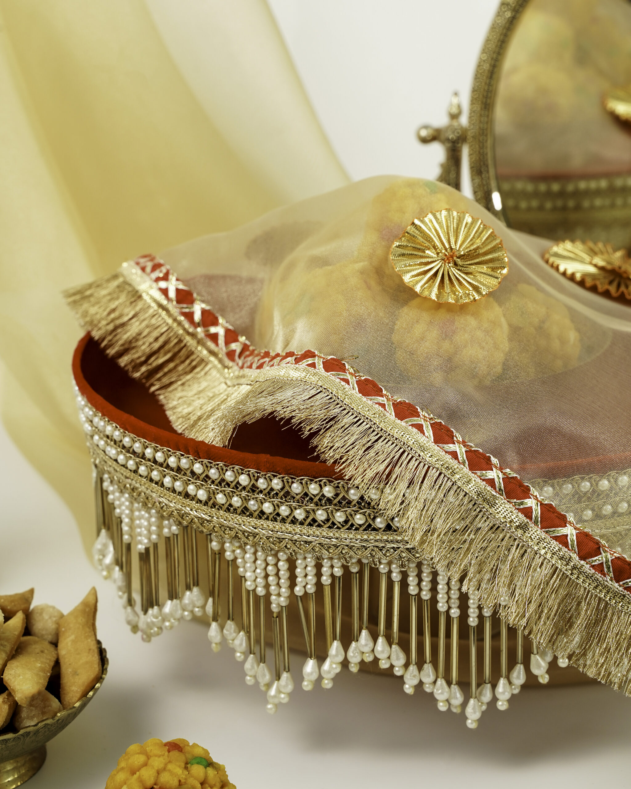 Beautiful Sindoori Shagun Thaal with Cover Sindoori Shagun Thaal with Cover by Navka Studio, beautifully decorated with pearls, golden fringe, and red velvet base, showcasing traditional Indian festive design.