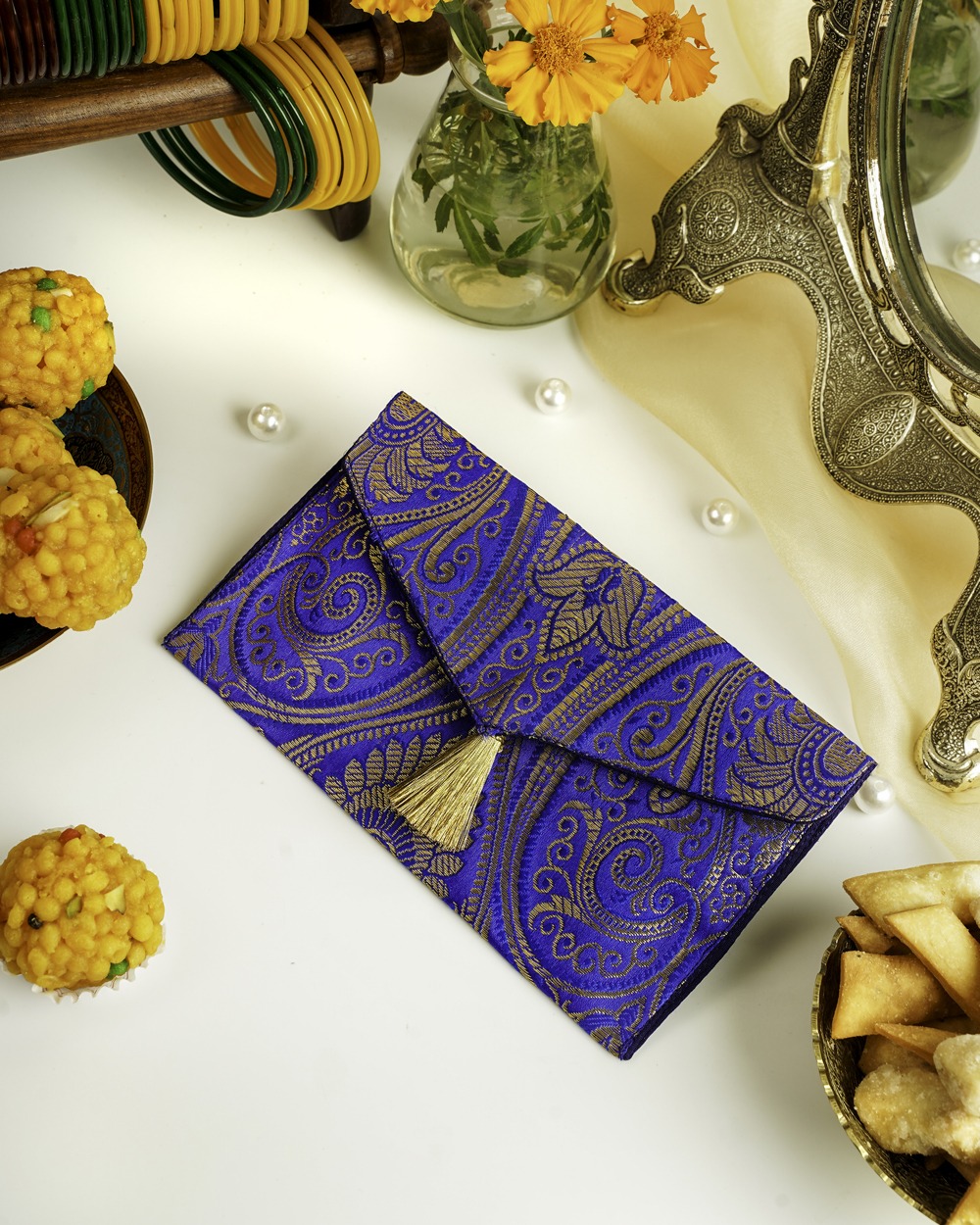 The Neelam Brocade Shagun Envelope by Navka Studio, displayed open with a cash note inside, showcasing its elegant design and navy blue interior lining.