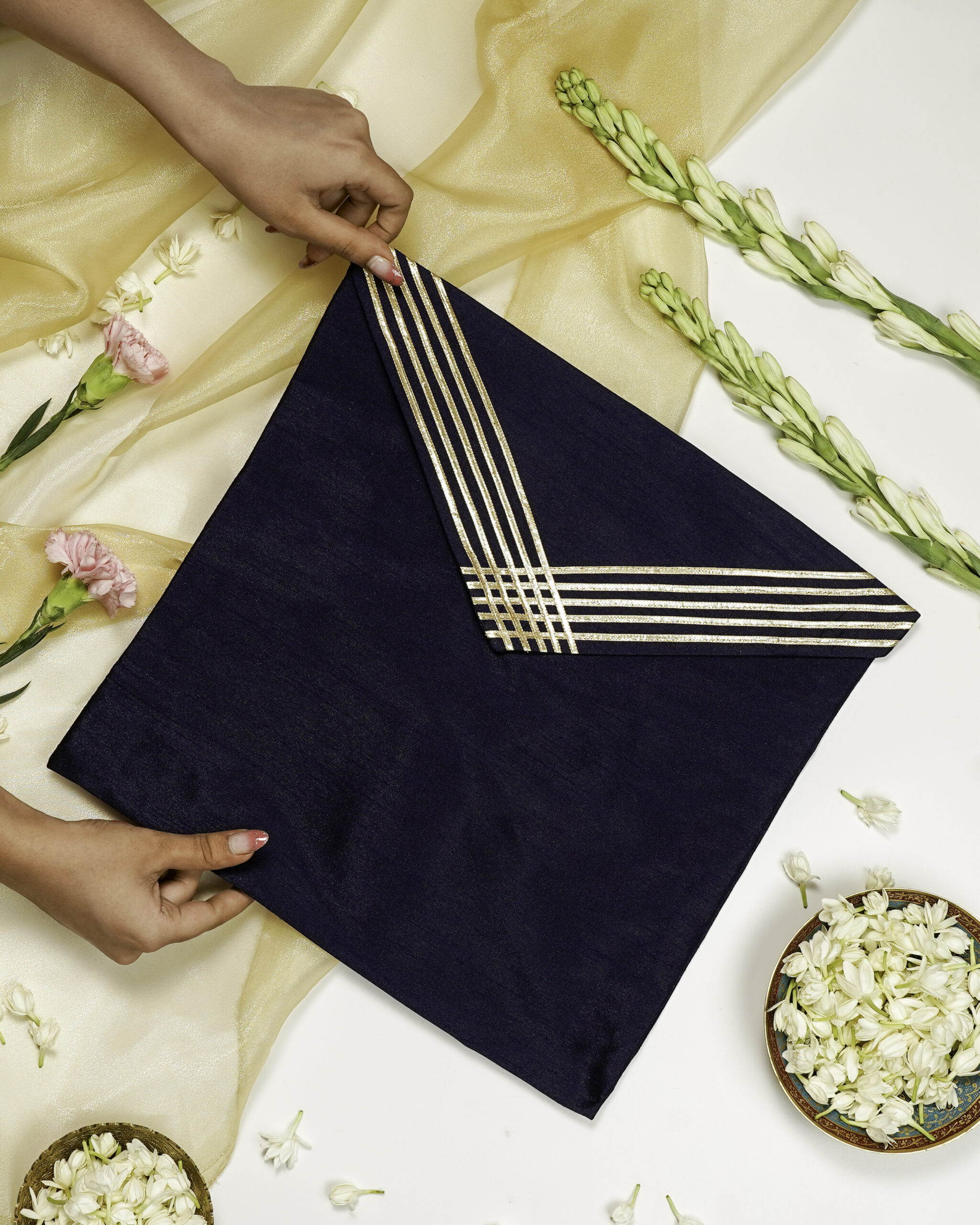 The Chandni Silk Grid Gota work Trousseau Bag from Navka Studio, featuring an elegant silver-toned grid design.