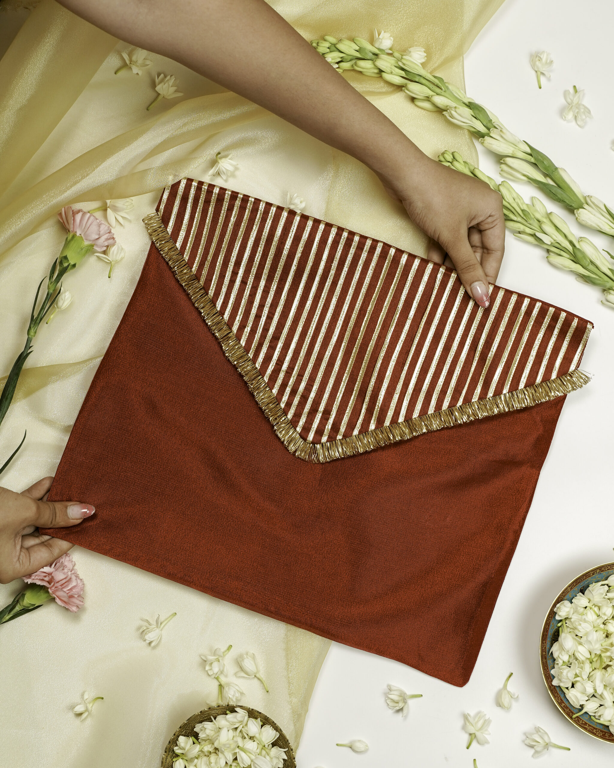 The Saaj Silk Full Gota work with Gold trims Trousseau Bag from Navka Studio, with decorative embroidery.