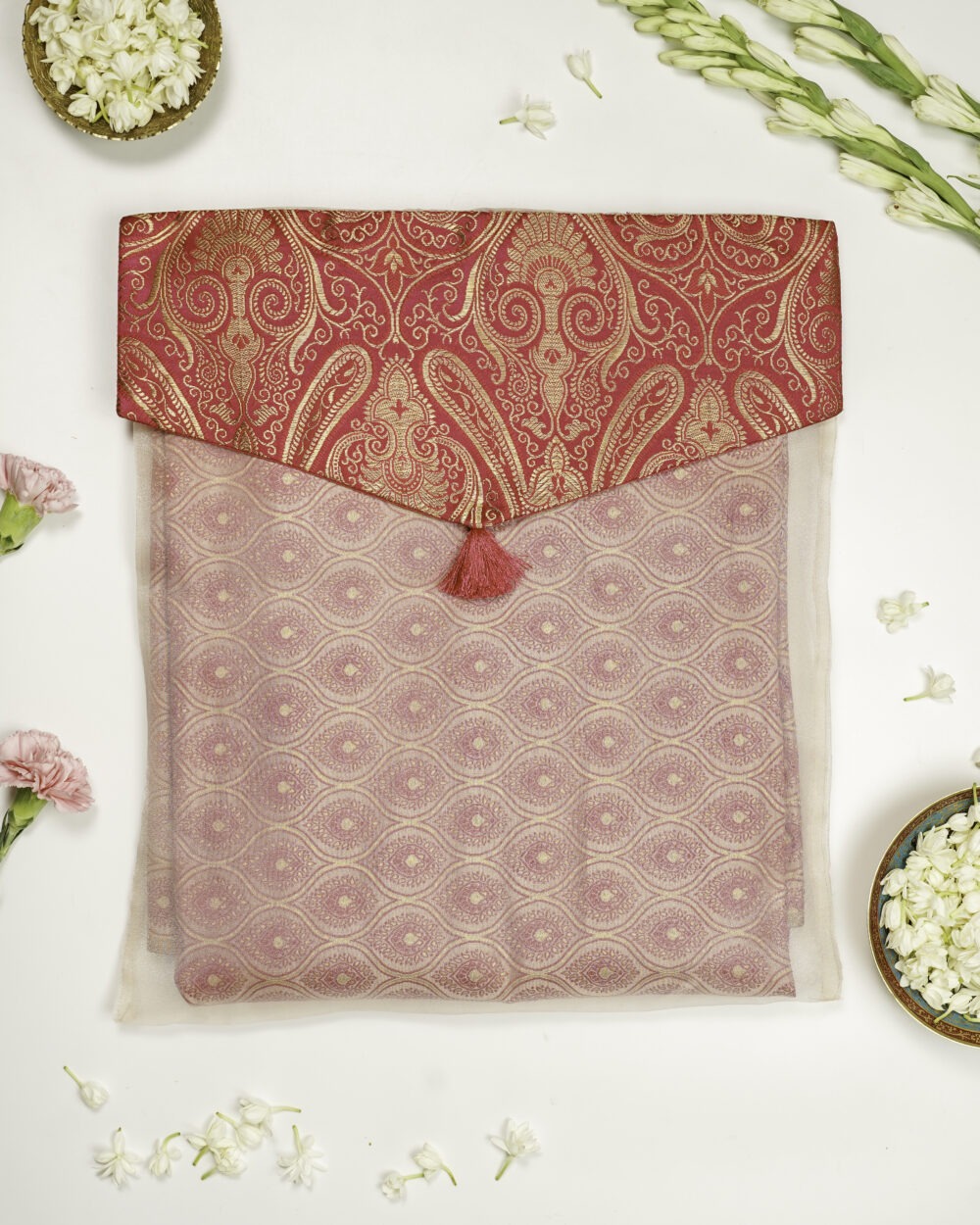 Navka Studio Gulzaar Brocade Silk & Organza Trousseau Bag showcasing elegant pink fabric and red-gold brocade flap with tassel.