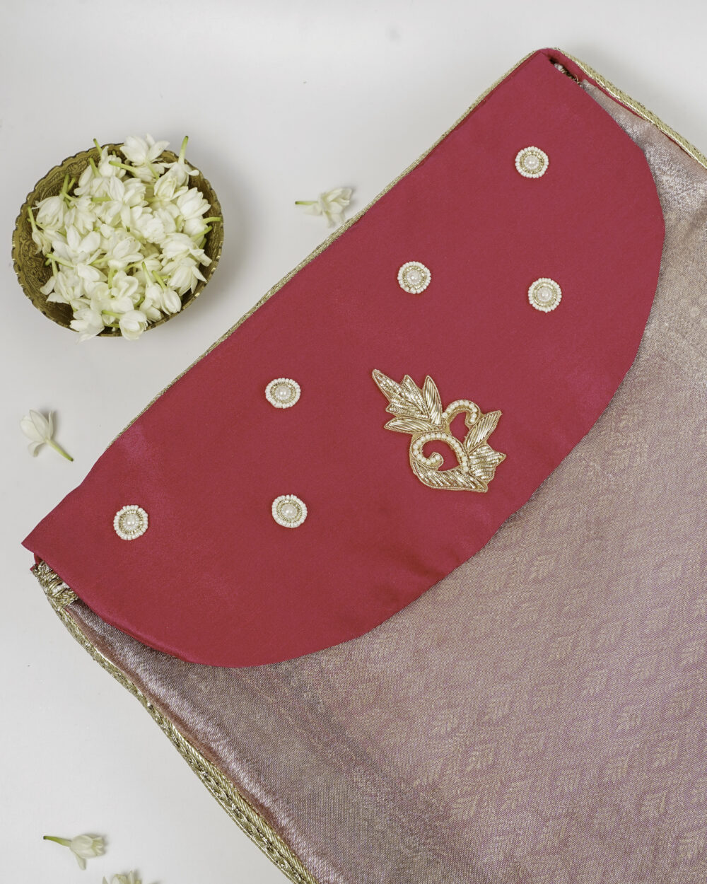 The vibrant pink and gold embroidered cover for the Gulzaar Rumala Sahib set by Navka Studio, with pearl embellishments.