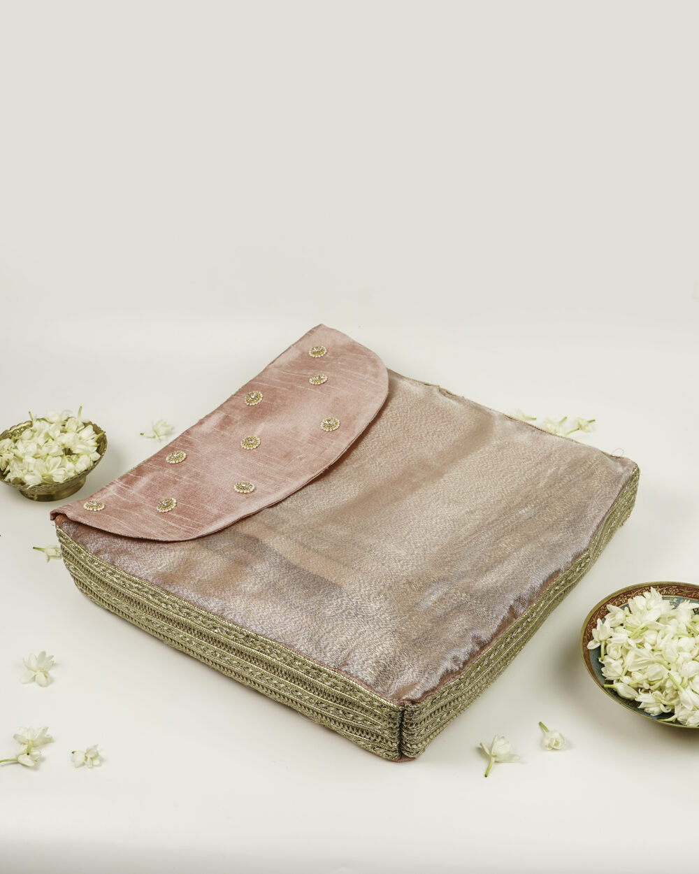 The delicate pink embroidered cover for the Bahaar Rumala Sahib by Navka Studio, with intricate gold motifs.