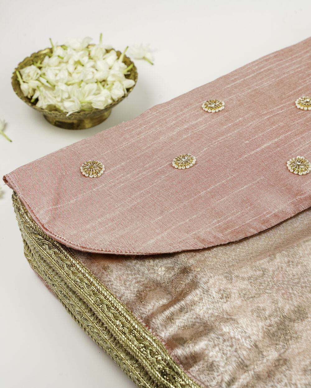 An elegant pink cover for the Bahaar Rumala Sahib by Navka Studio, adorned with gold embroidery and embellishments.