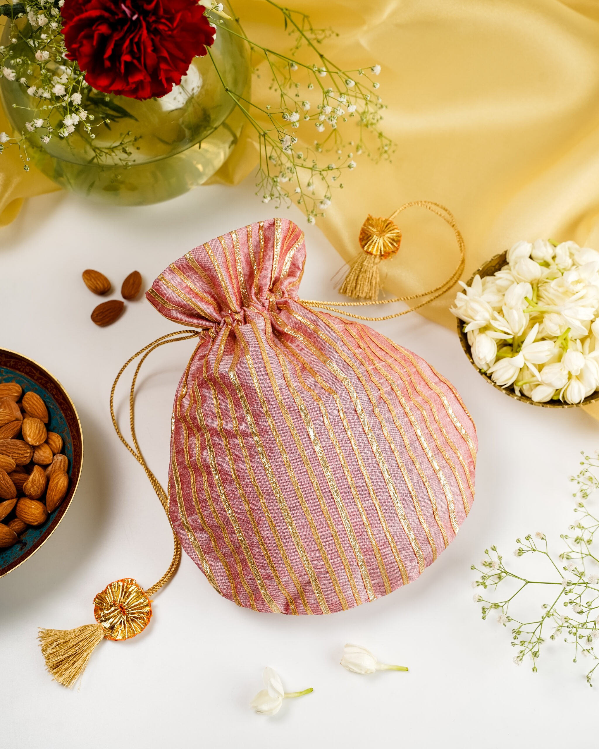 The festive Bahaar Silk & Gota Work Potli by Navka Studio, featuring delicate embroidery on a silk base.