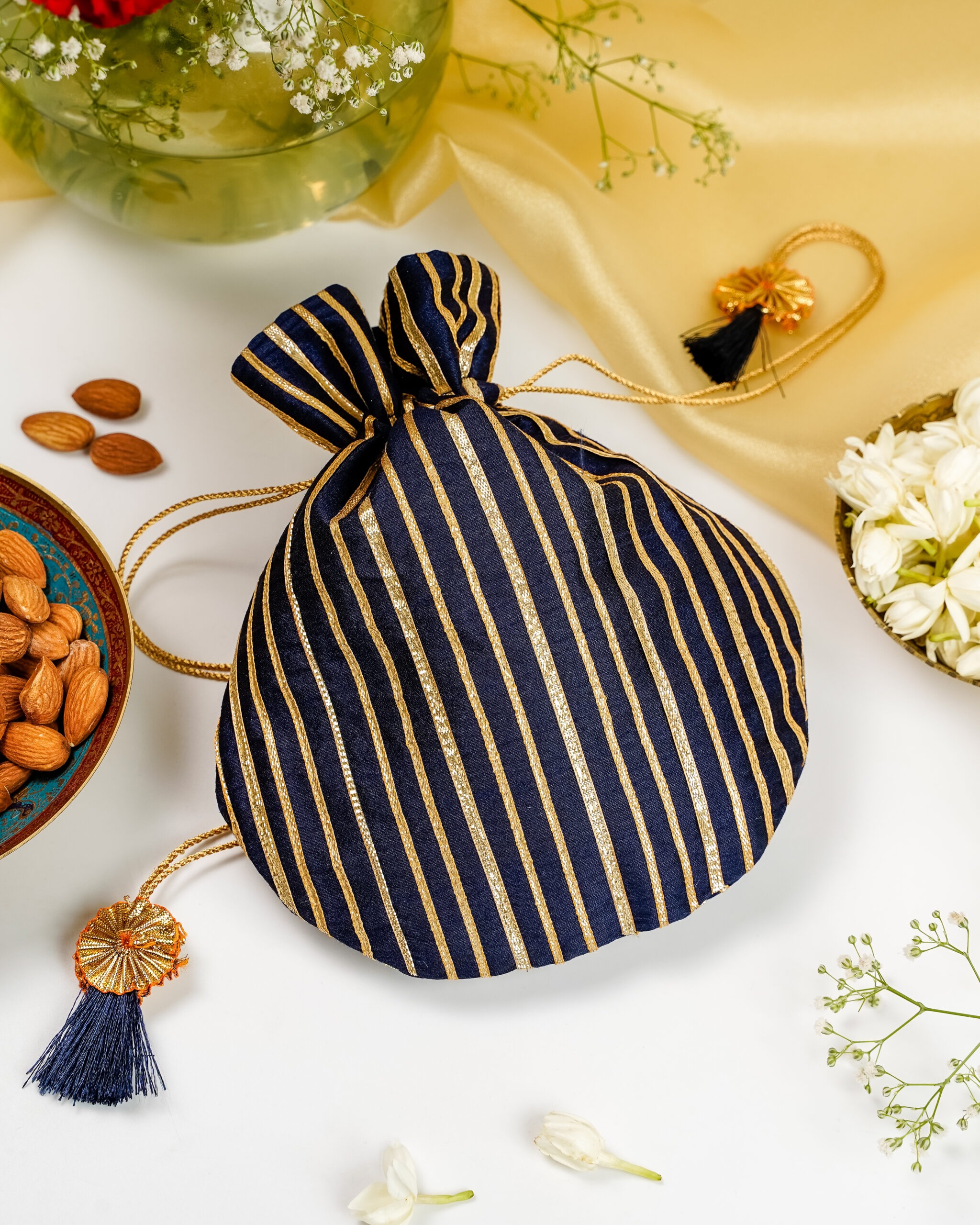 An elegant Chandni Silk Potli by Navka Studio, adorned with delicate silver gota work for an evening look.