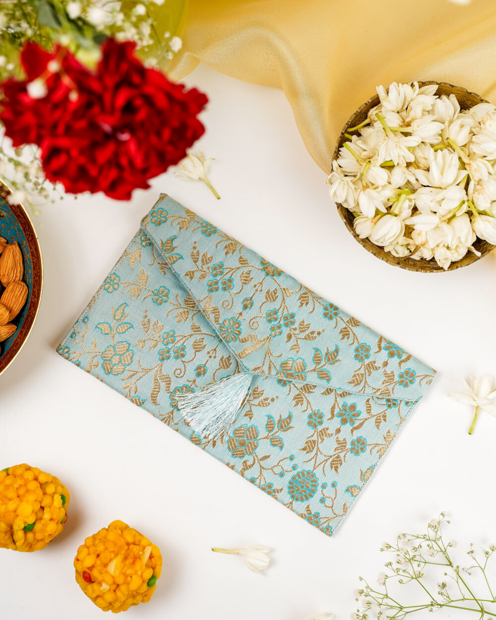 Seher Brocade Shagun Envelope by Navka - Silk brocade with tassels, styled with flowers and sweets for Navratri festive gifting by Navka.