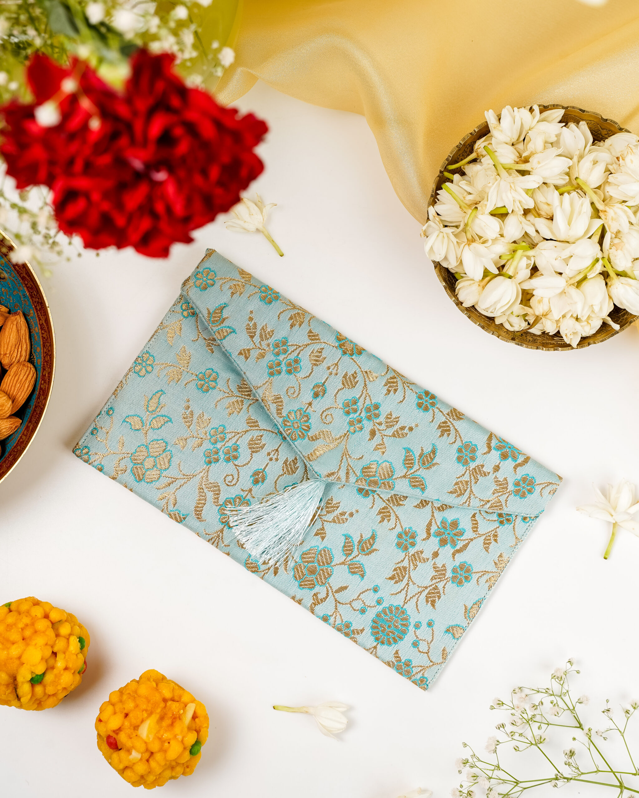 Seher Brocade Shagun Envelope by Navka - Silk brocade with tassels, styled with flowers and sweets for Navratri festive gifting by Navka.
