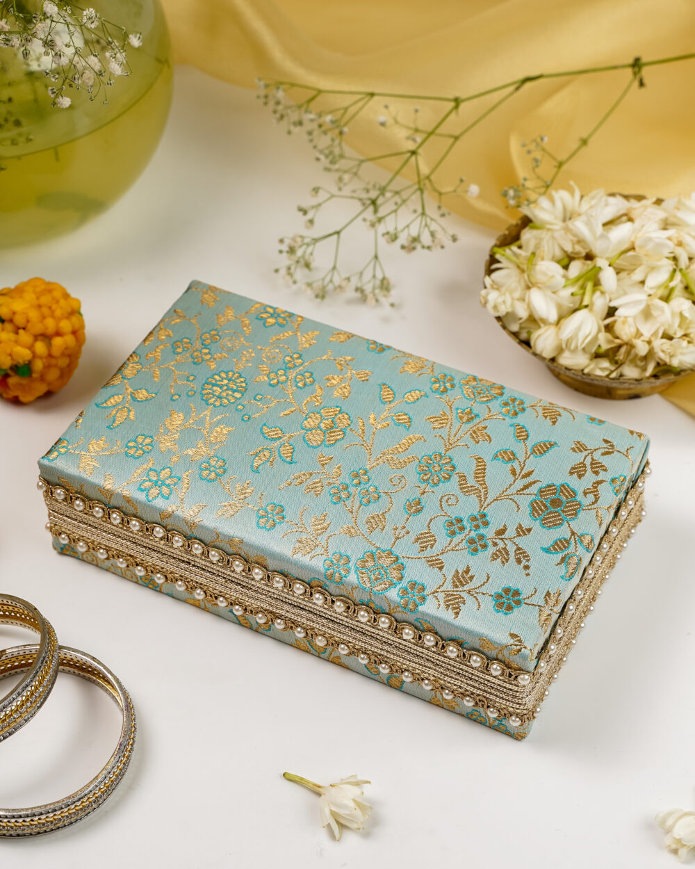 The large, rectangular Seher Double Brocade Kada Box by Navka, in light blue and gold, for storing bridal jewellery sets.