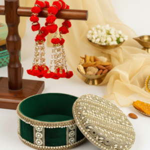 Navka Studio's punjabi wedding in 2025, Red Ganne and green ladoo box.